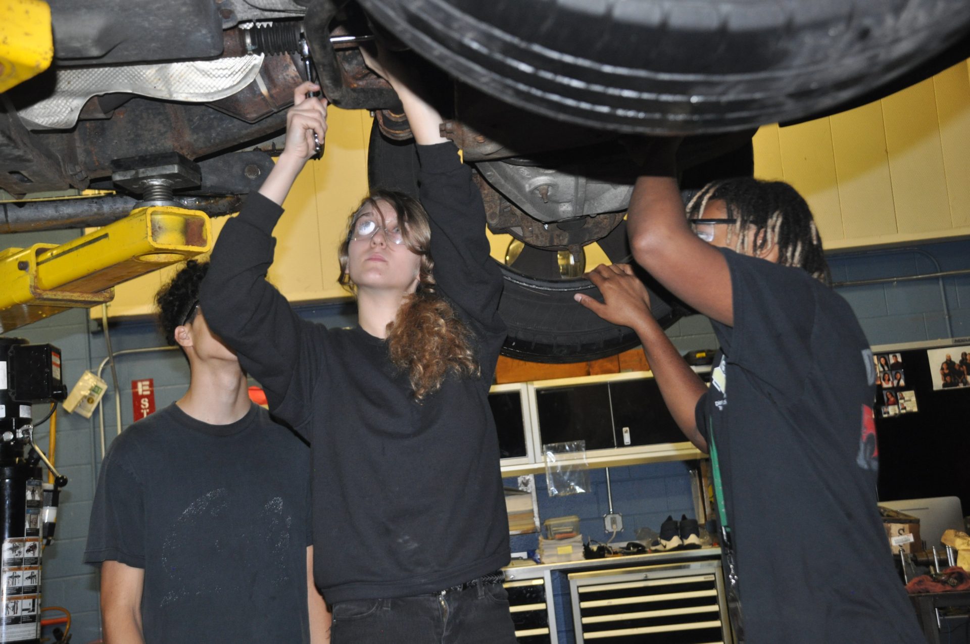 Diesel students working under a vehicle