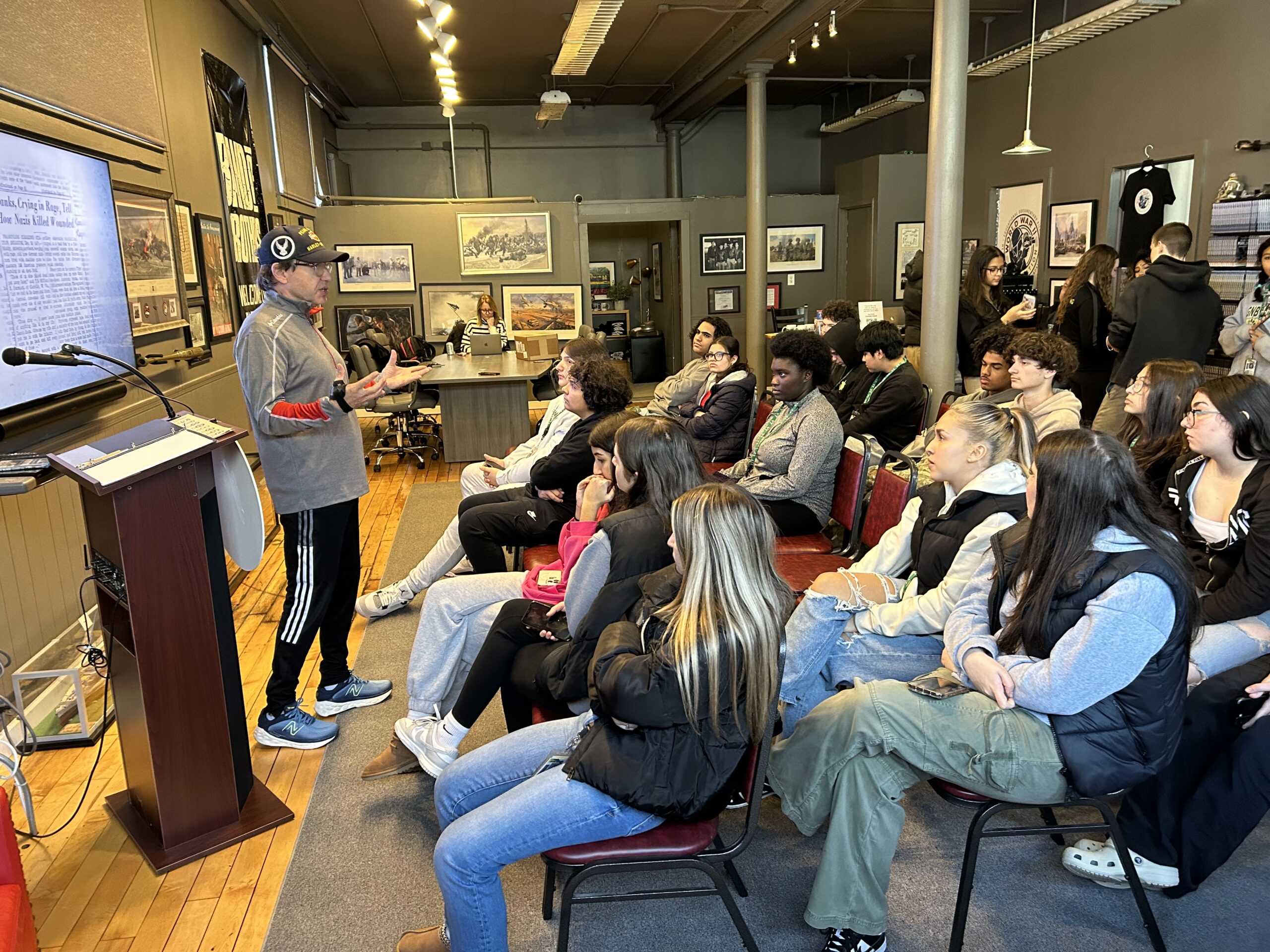 group of students listening to man speak