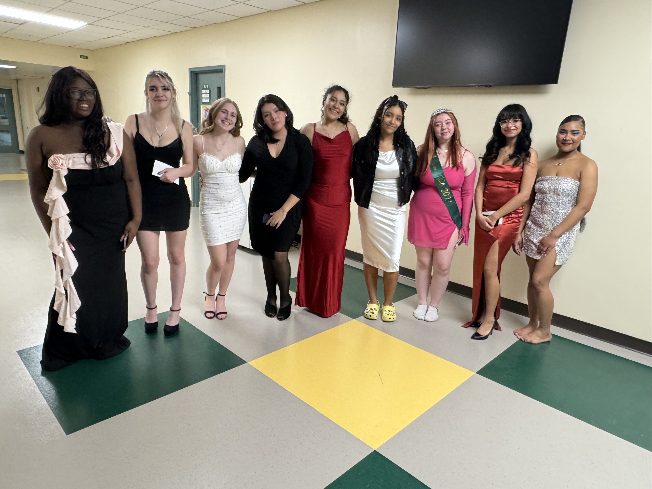 group of students posing in a line wearing fancy dresses