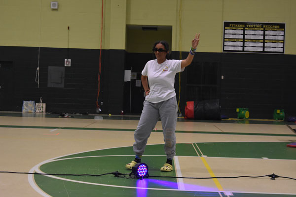 Kid striking a pose during the hypnotist show at the 2024 after prom