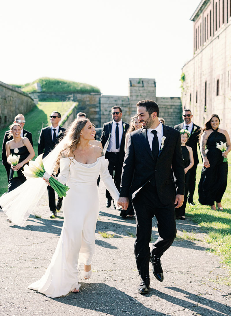 alumni colton simmons wedding photography work of a married couple walking with their wedding party