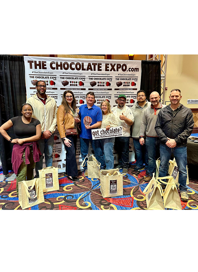 alumni spotlight Chef Henry at the Chocolate Expo with GNBVT coworkers