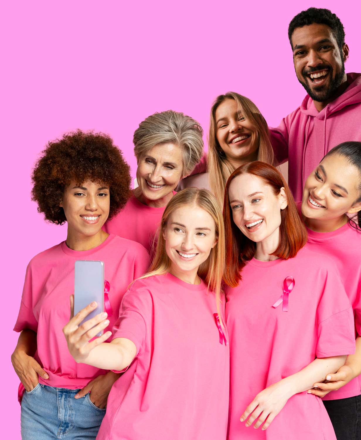 diverse group of people wearing pink and taking a selfie