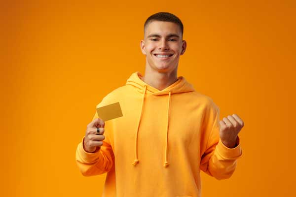 Student smiling wearing all yellow with a gift card