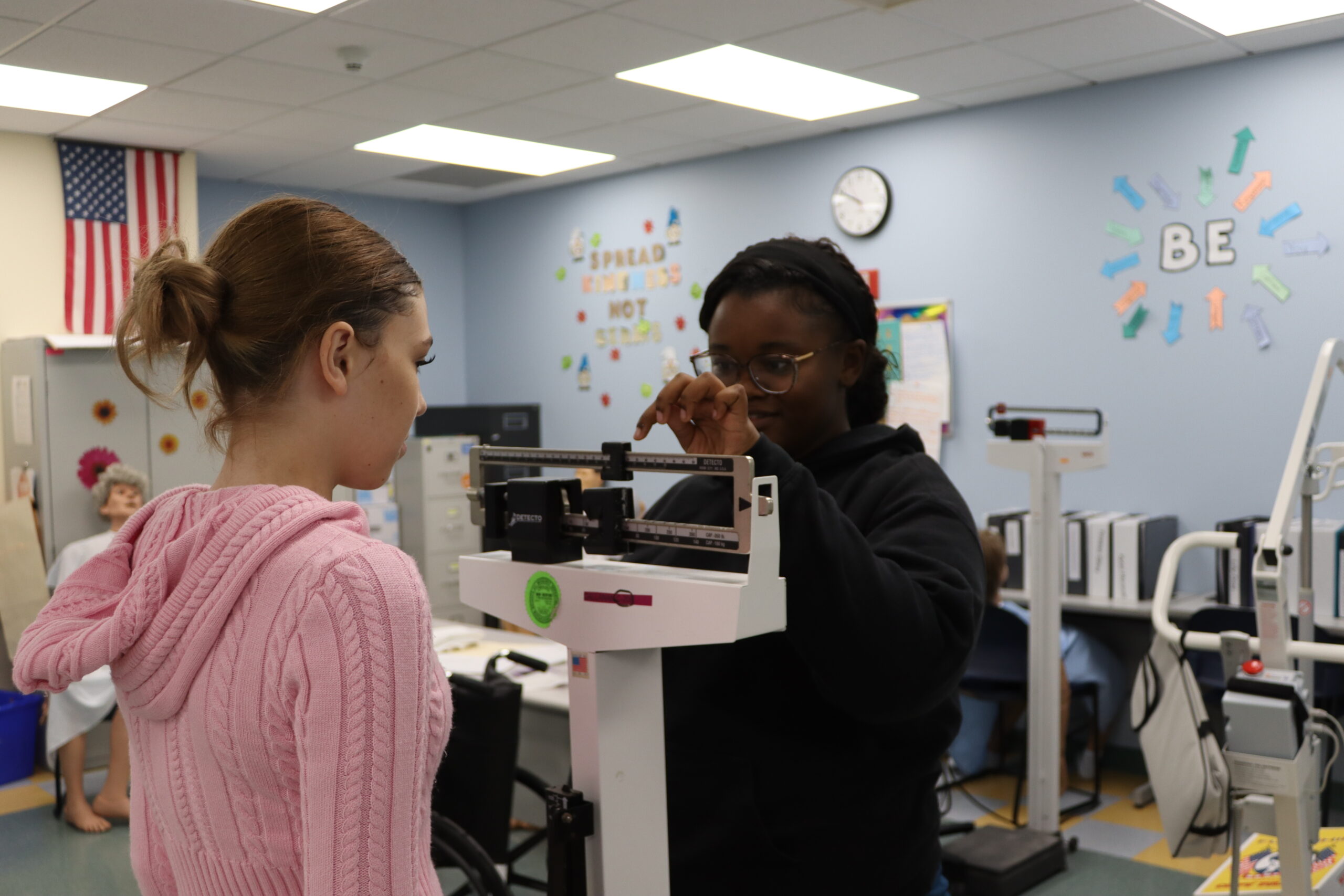 Nursing student measuring weight