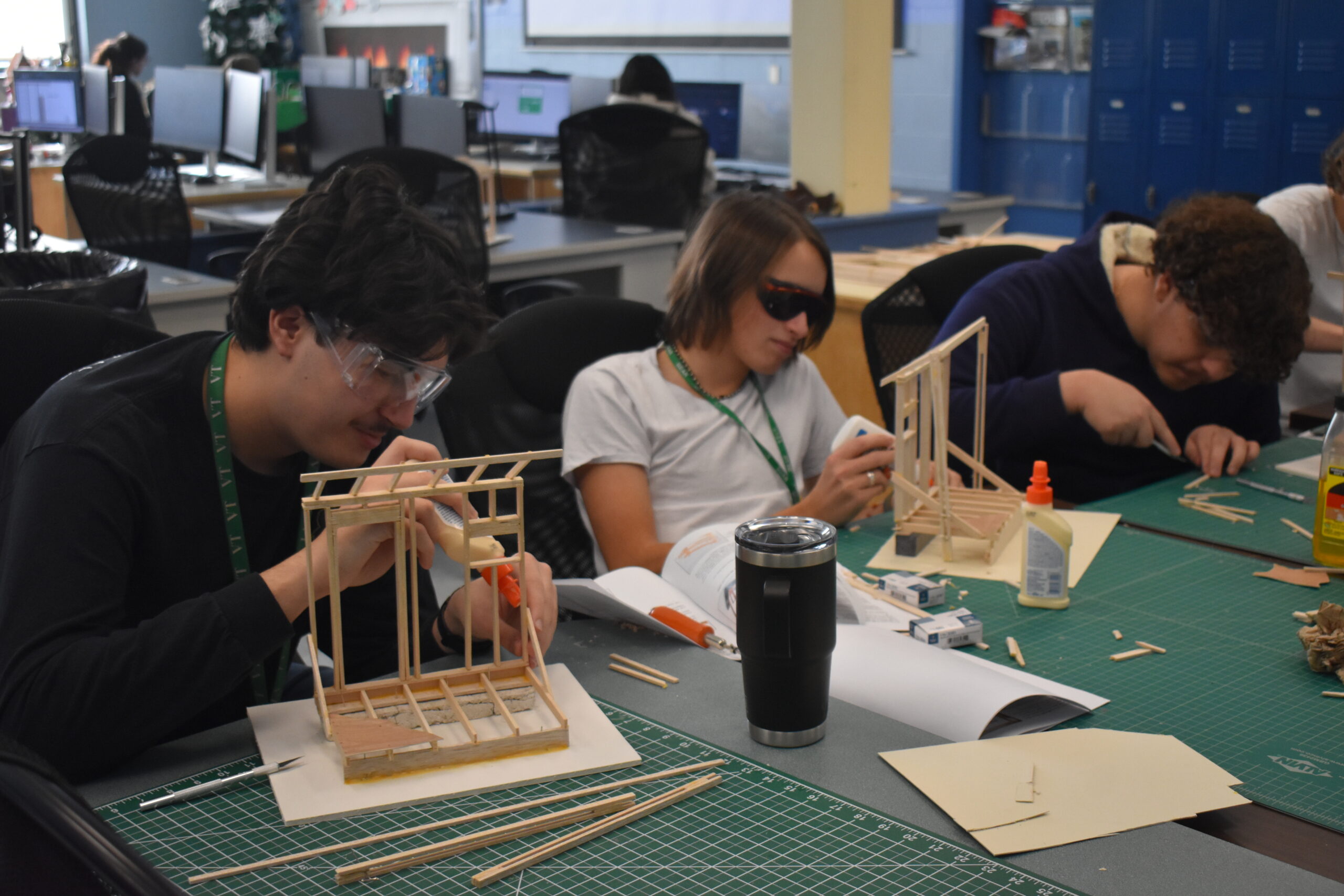 Students working on putting together houses