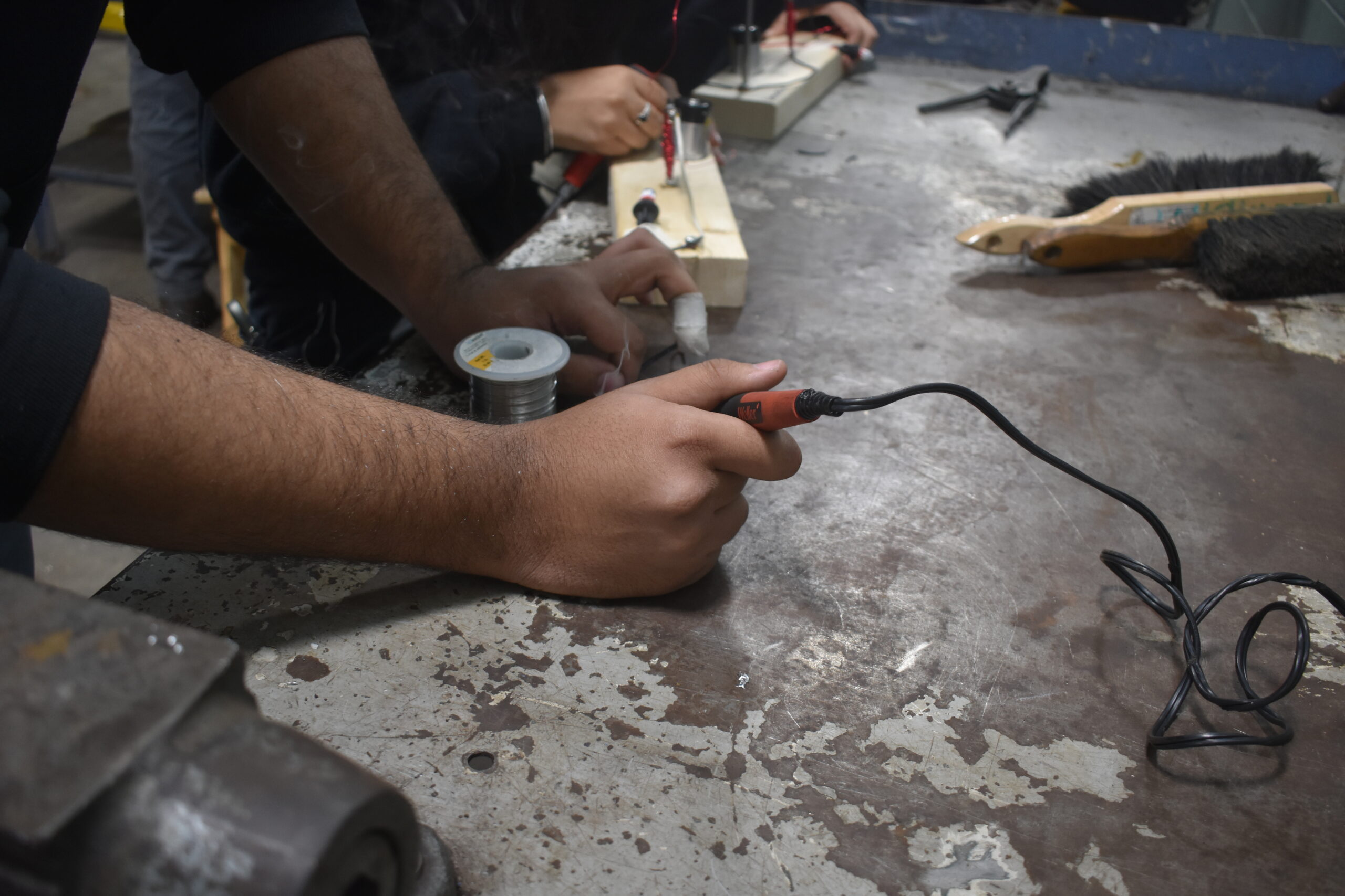 A person using tools in the shop