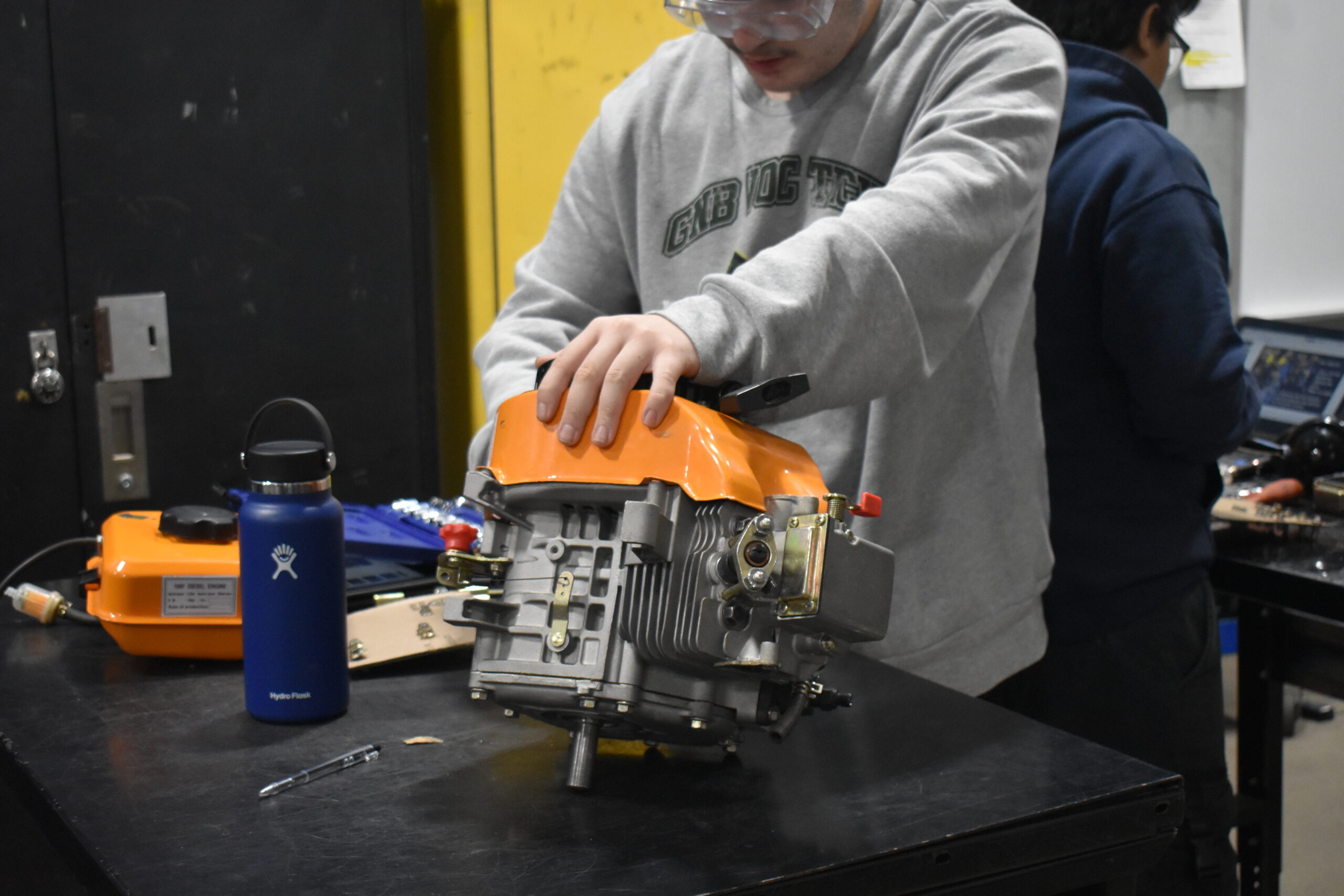 Student fixing a machine