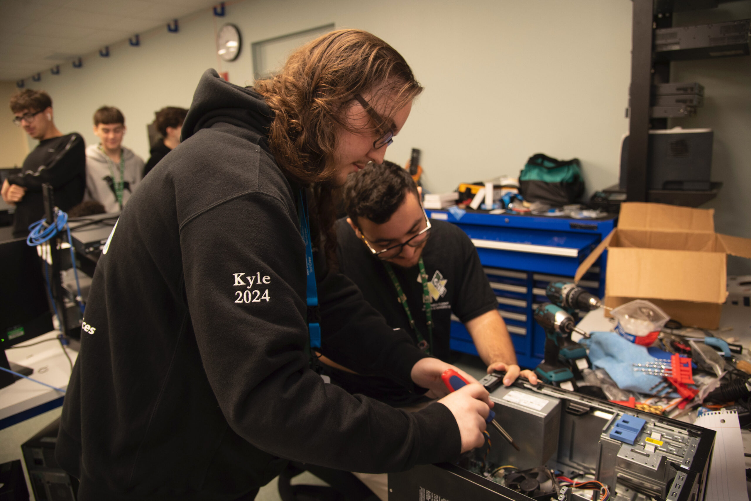 Students working on fixing computer together