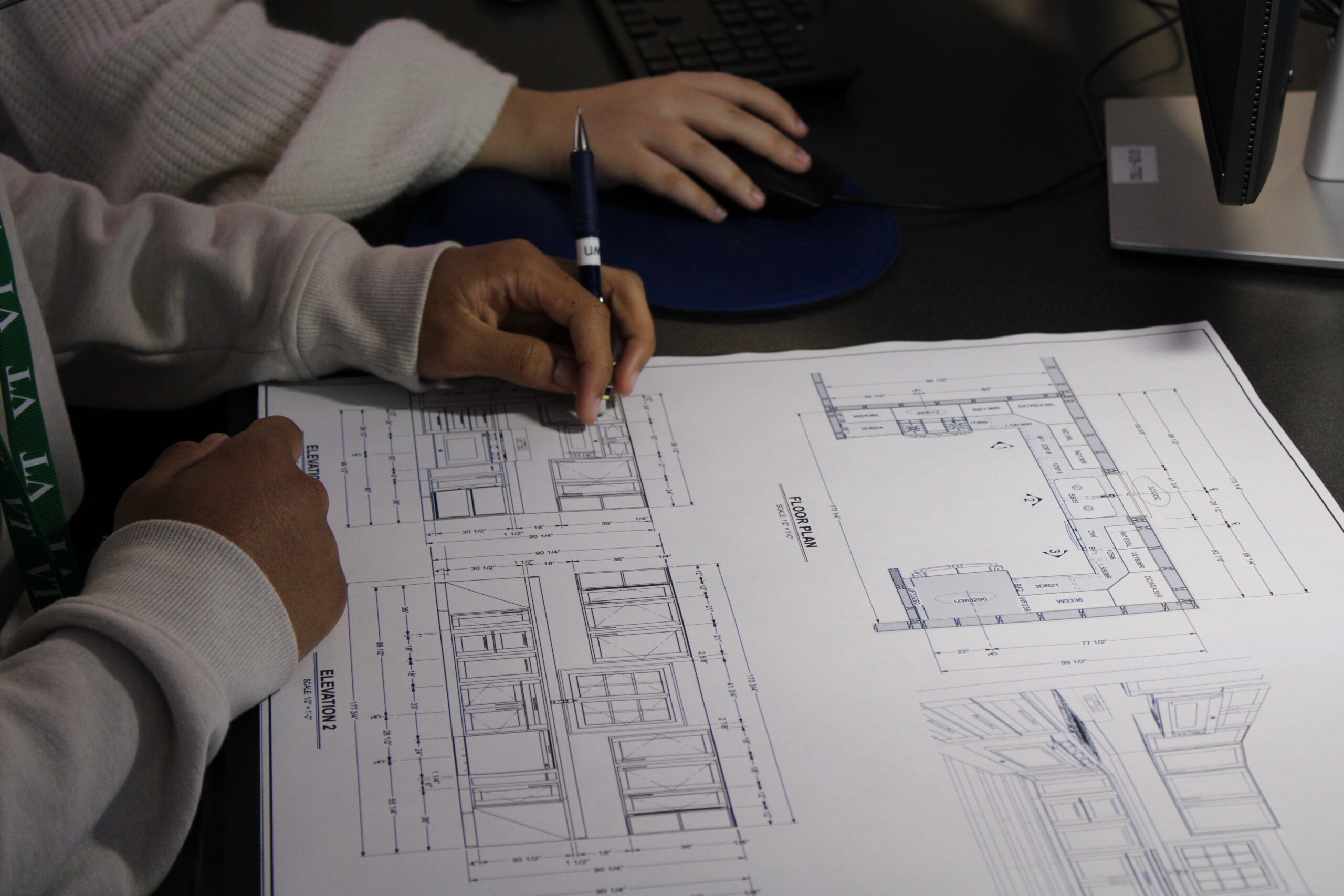 A student looking at a blueprint. 