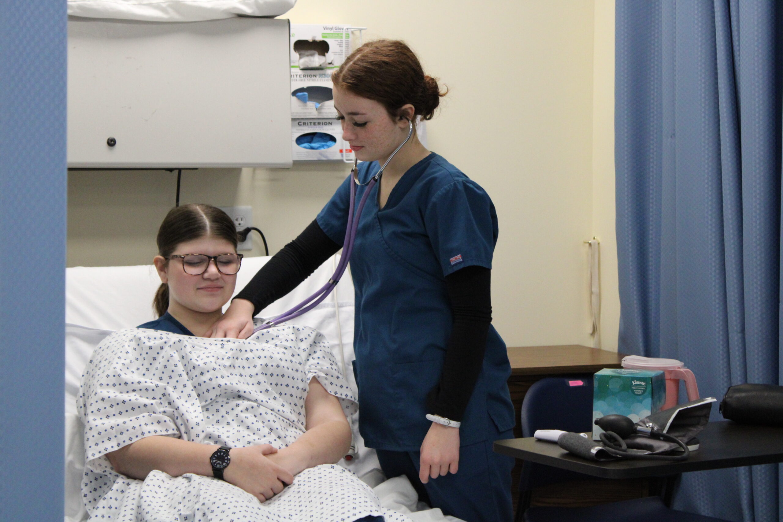 Nursing student checking heart beat