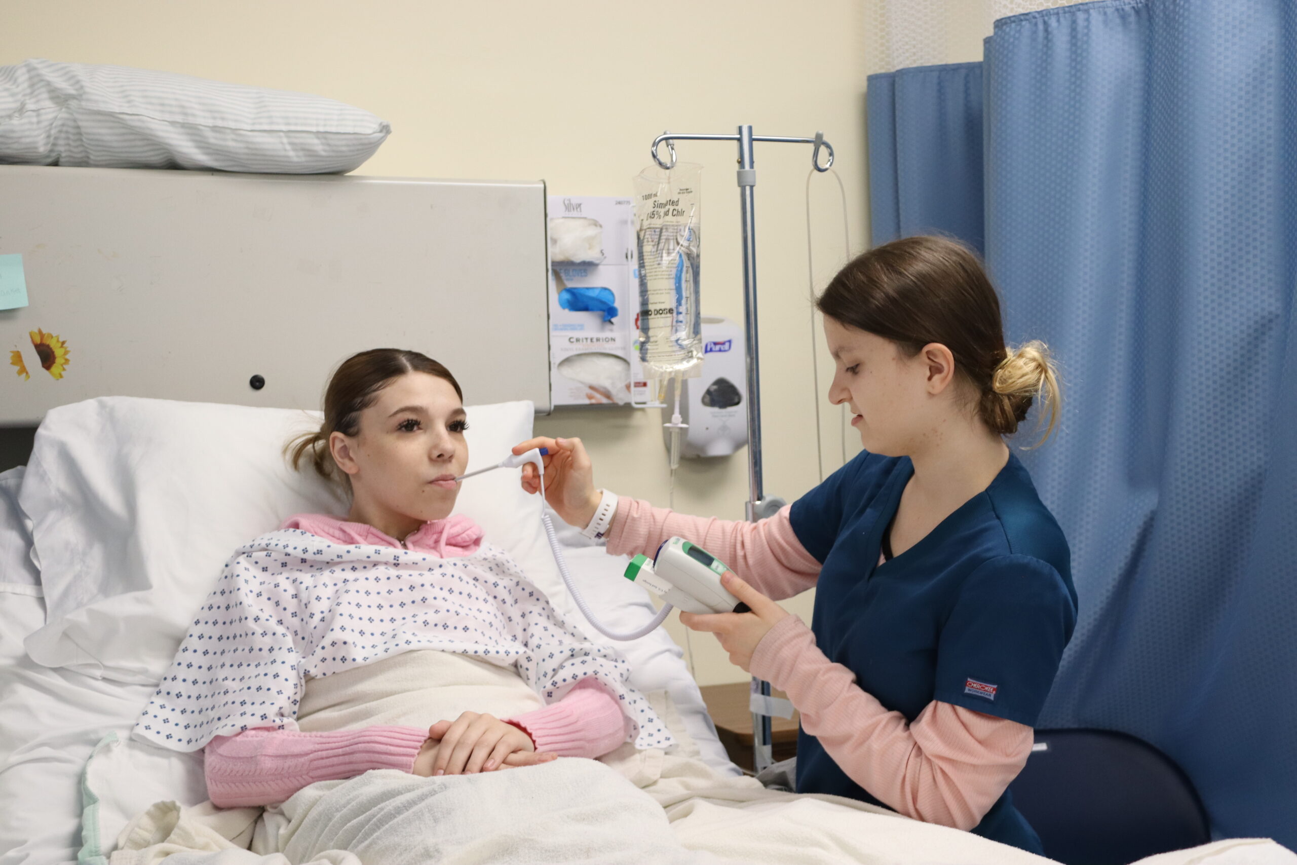 Nursing student taking temperature