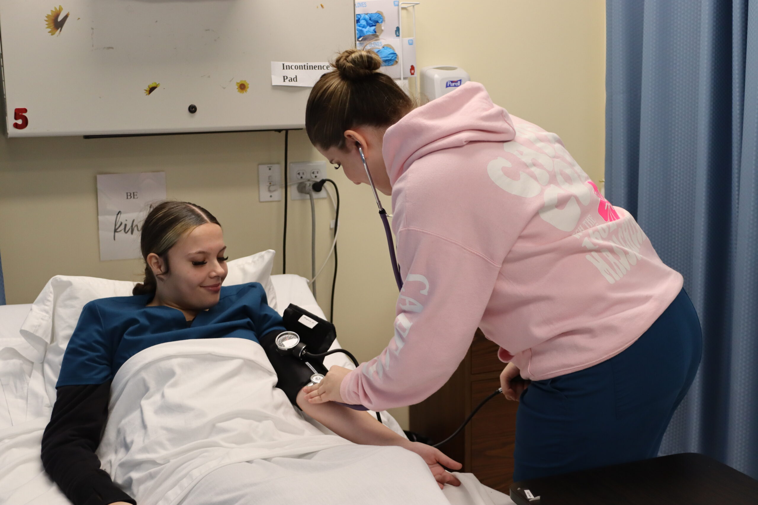  Nursing student taking blood pressure