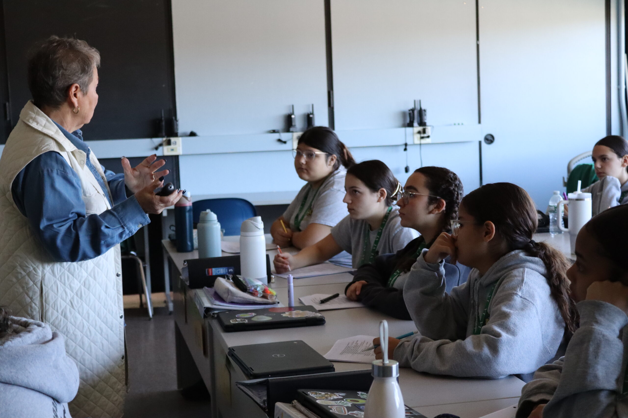 Students working diligently listening to a lecture. 