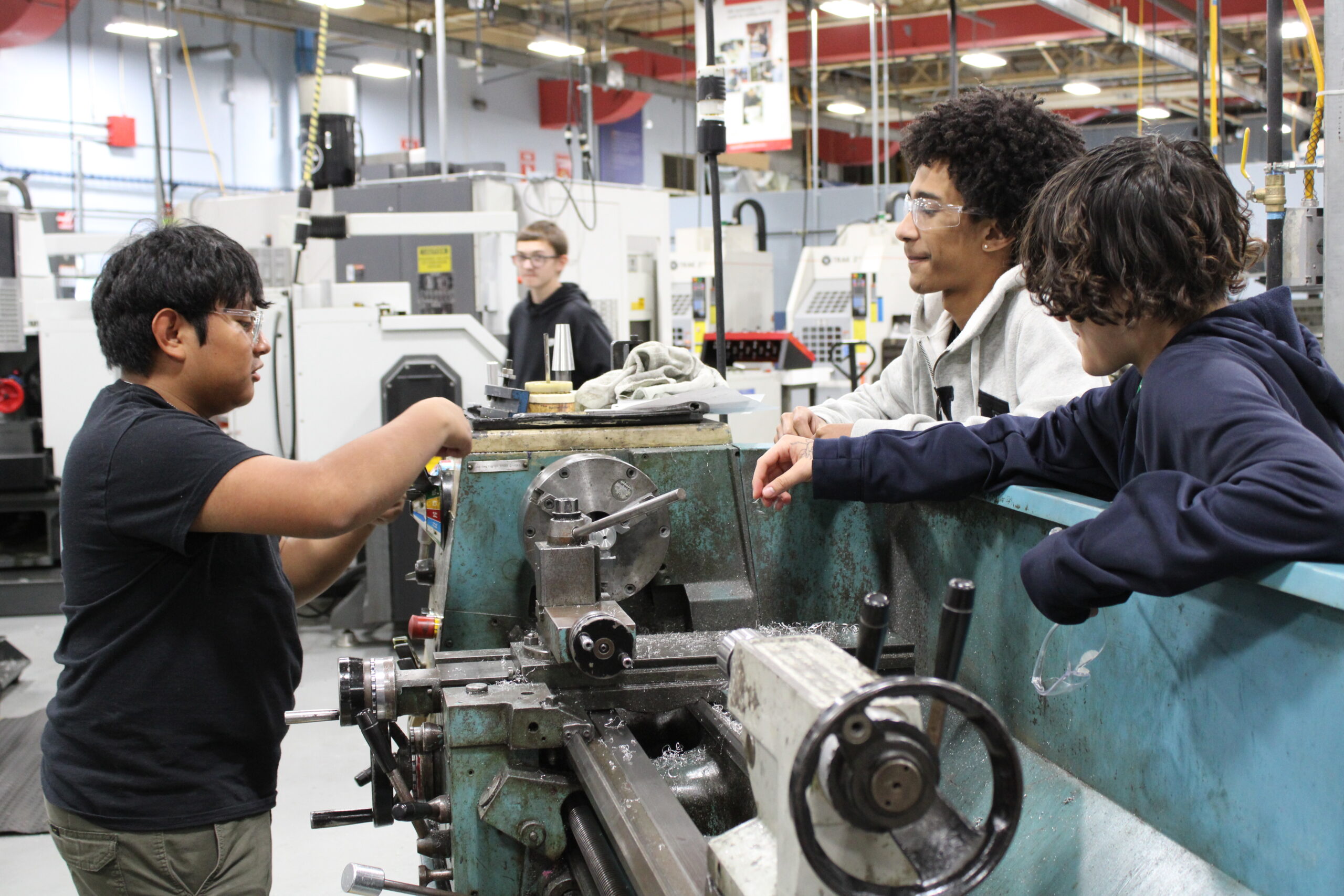 Students hanging around a machine socializing