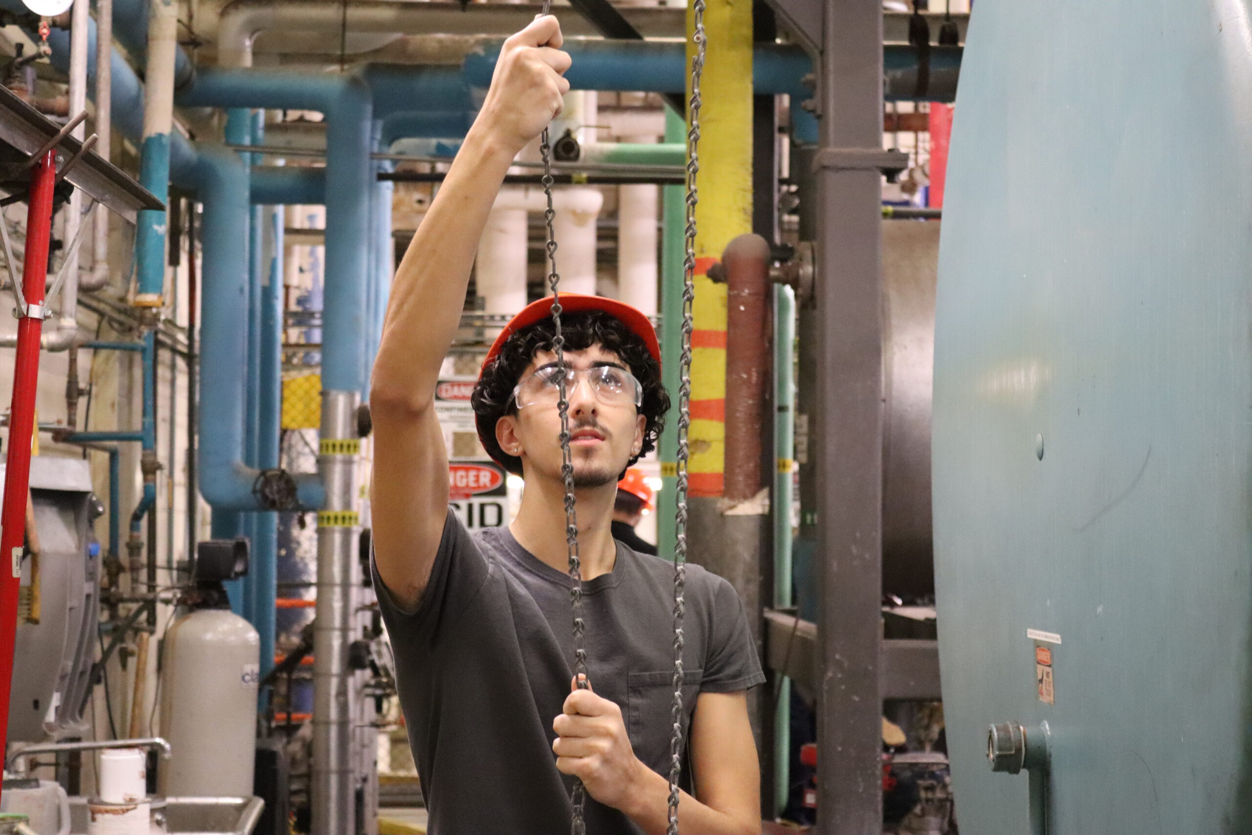 STEAM Student manually adding water the the boiler