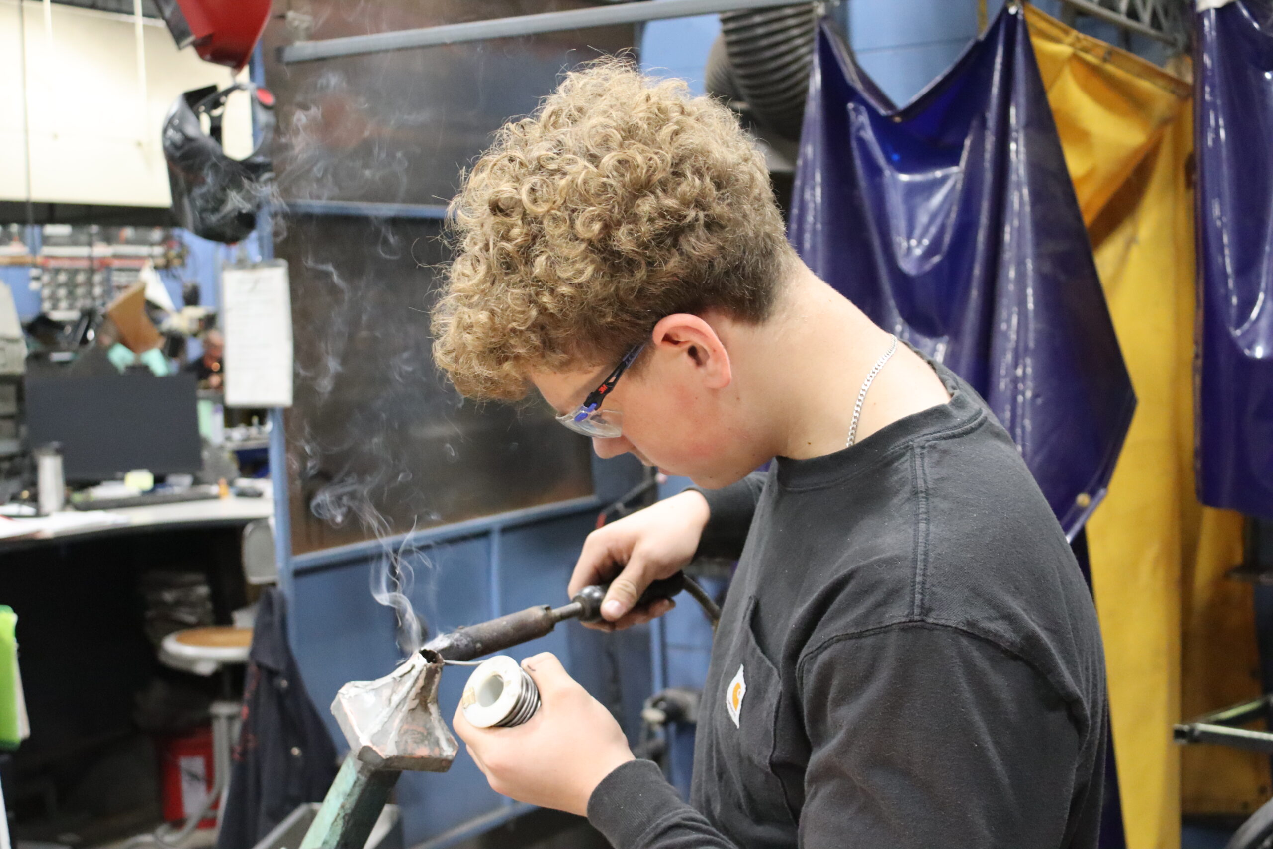  Metal Fabrication student heating up a metal pipe