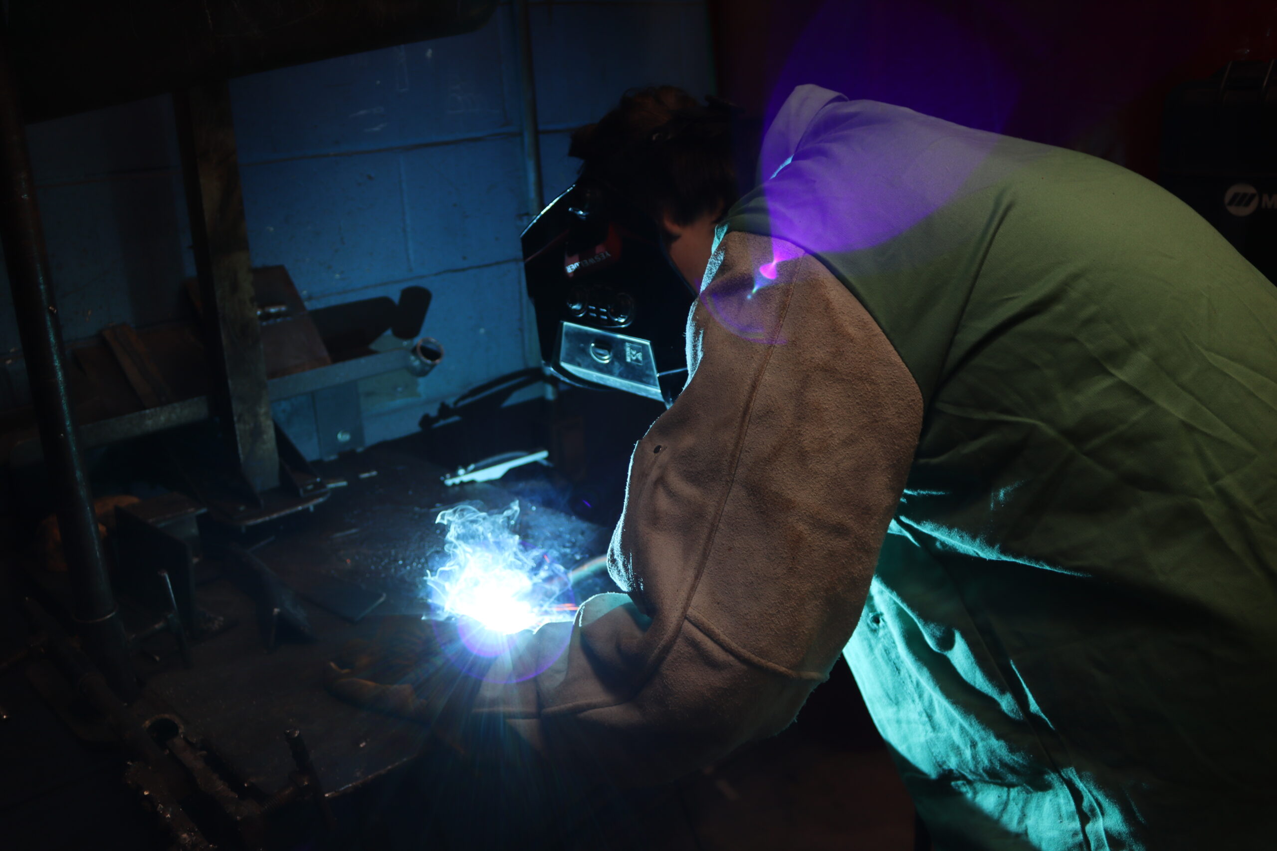 Metal Fabrication student in a torching booth