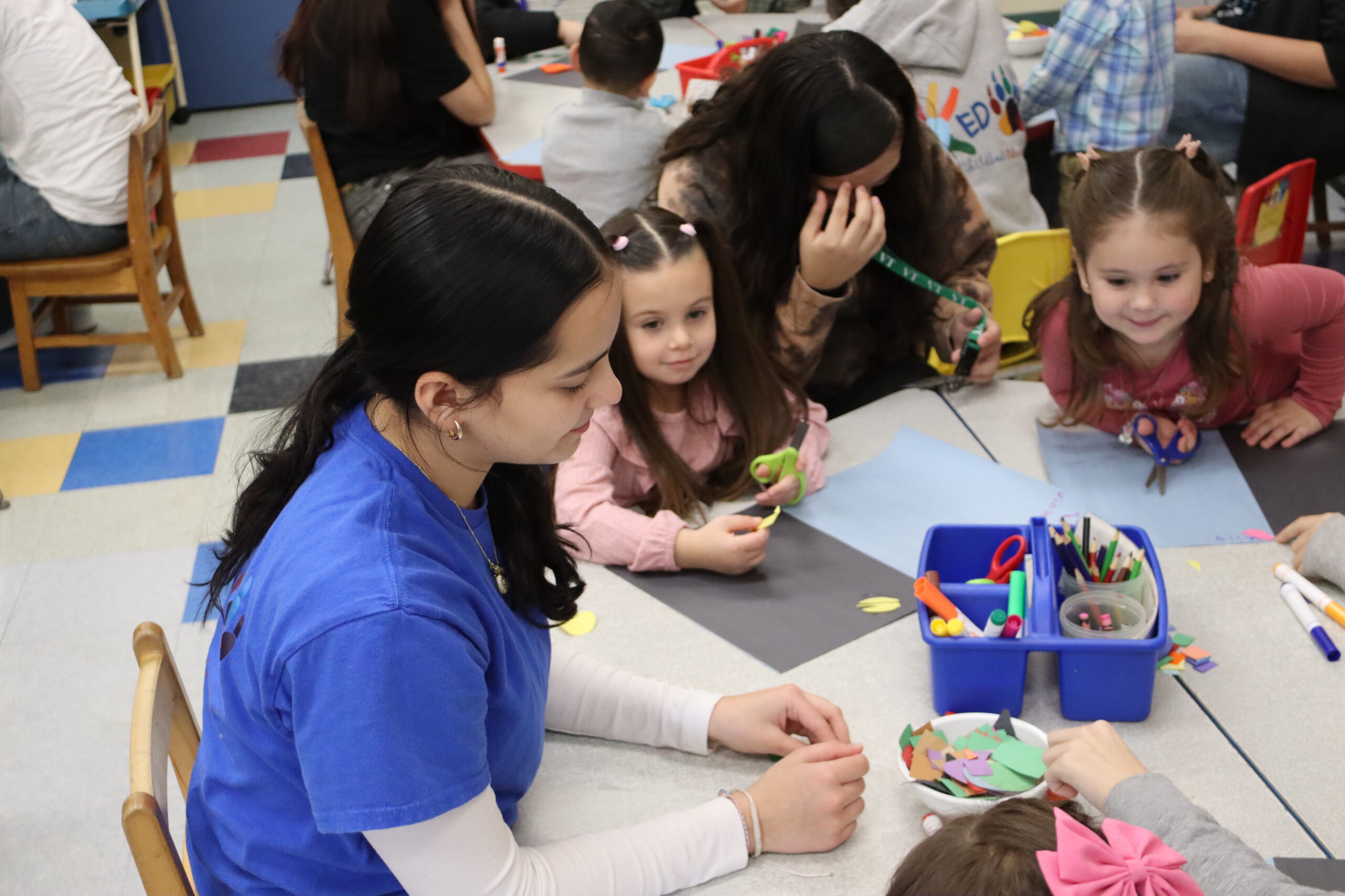 Early Childhood student working with children on art project