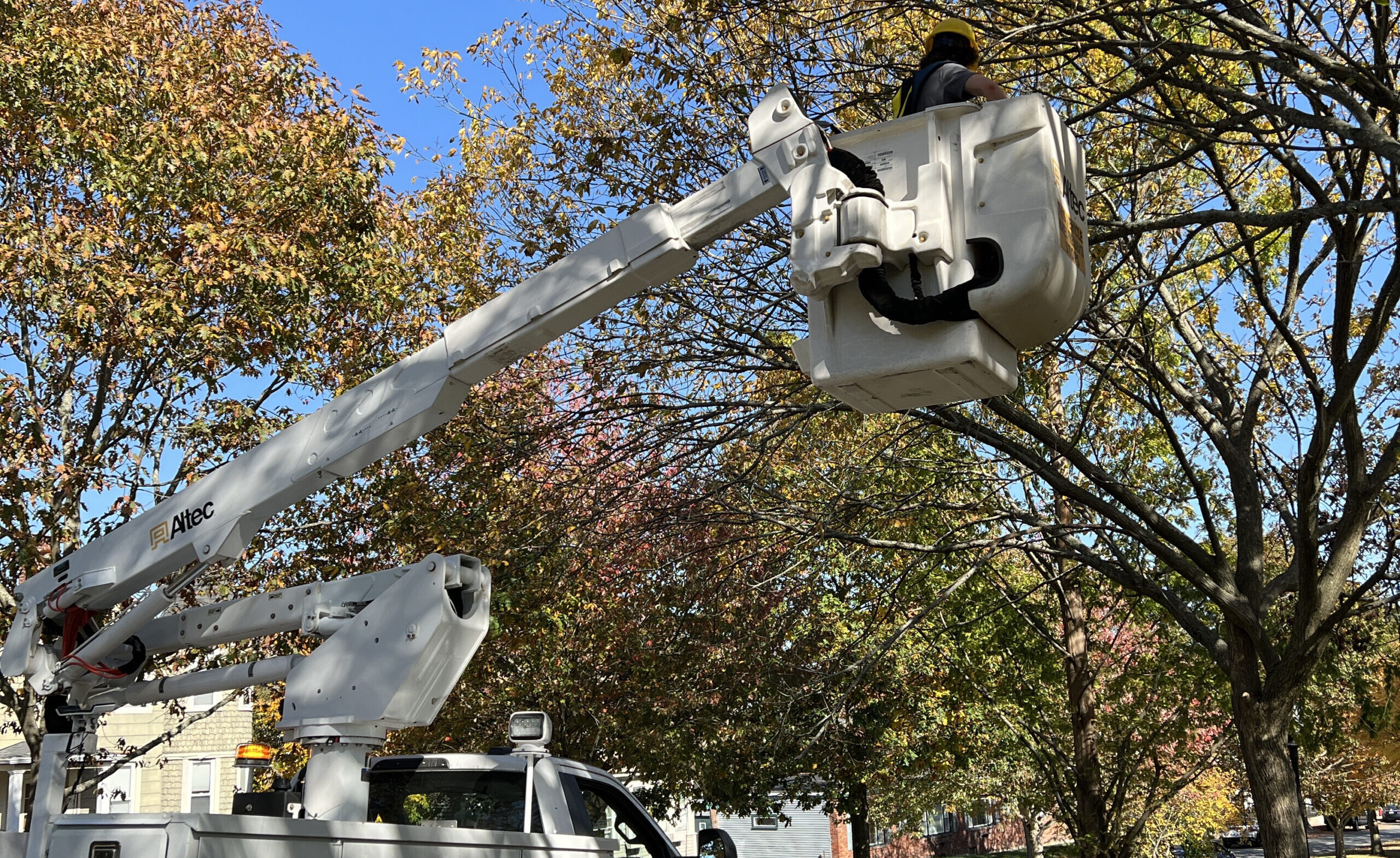 A student inside of a crane being controlled by a truck.