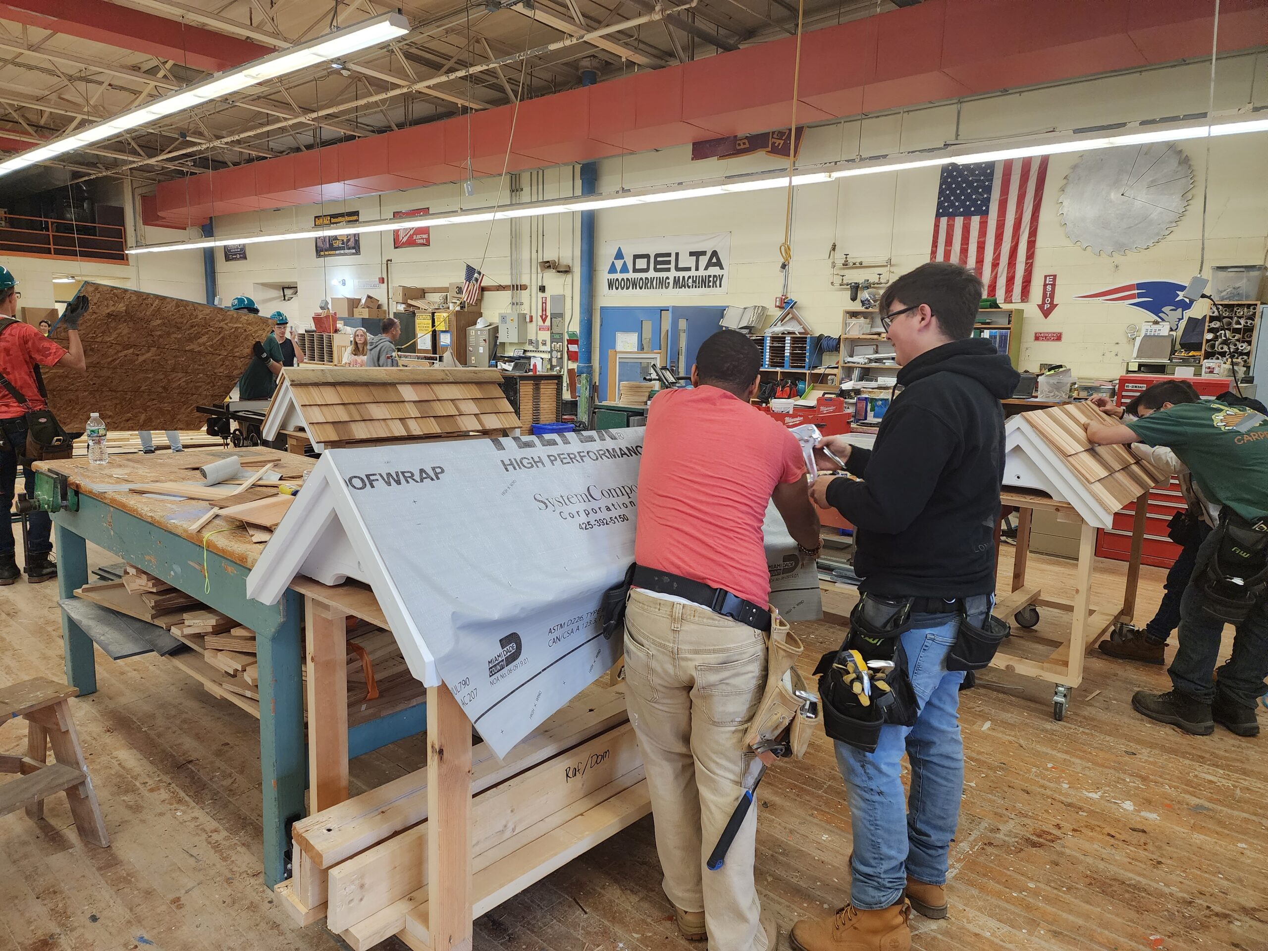 Students using a machine in shop