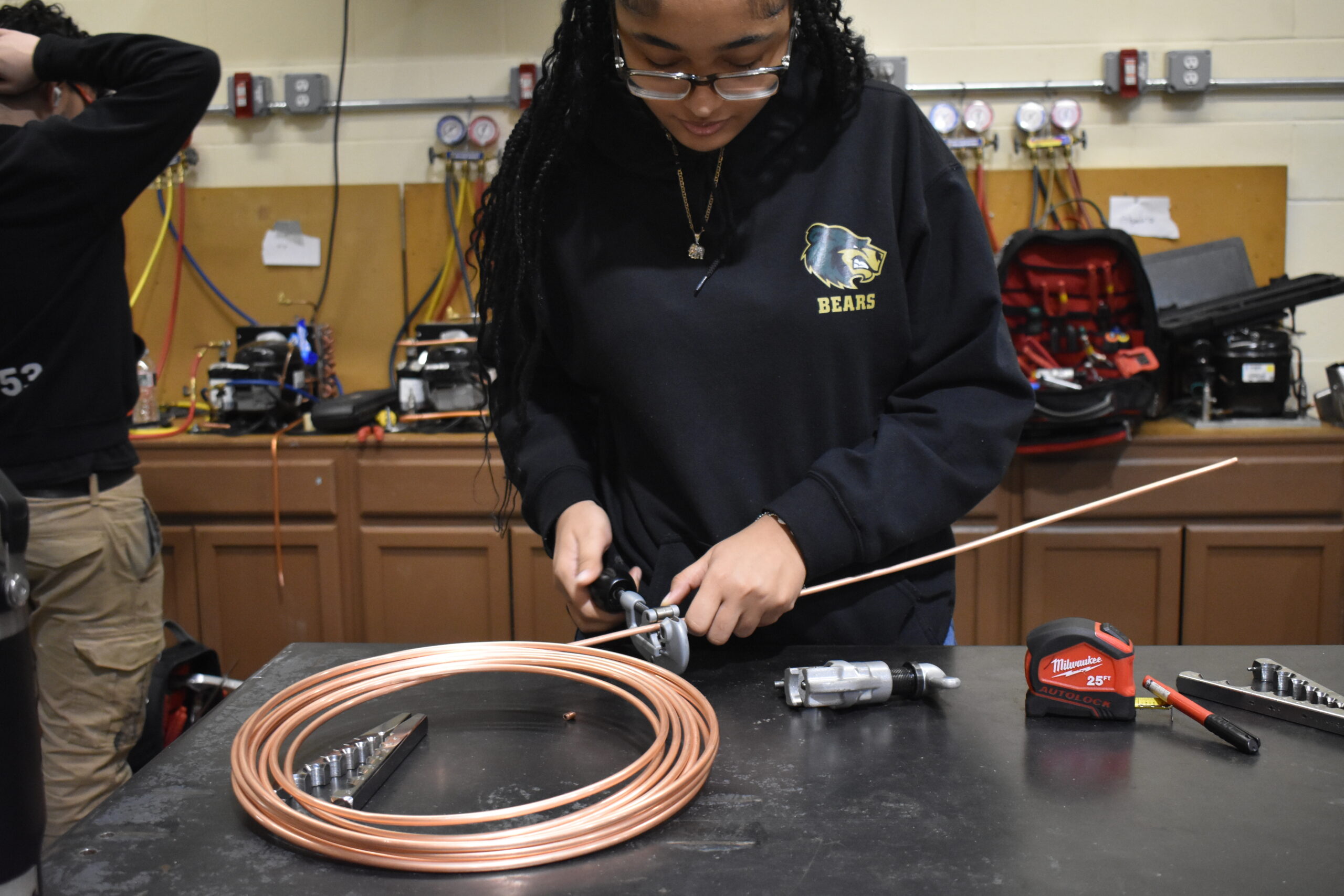 Student cutting metal