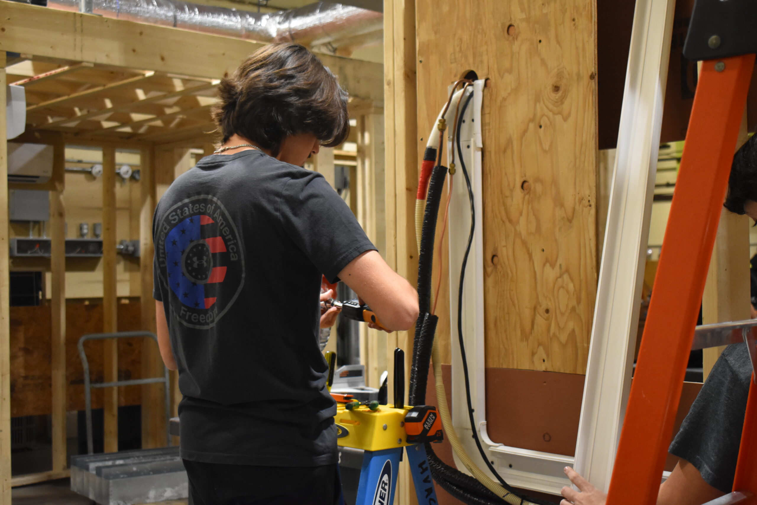 Student working on side of the wooden board