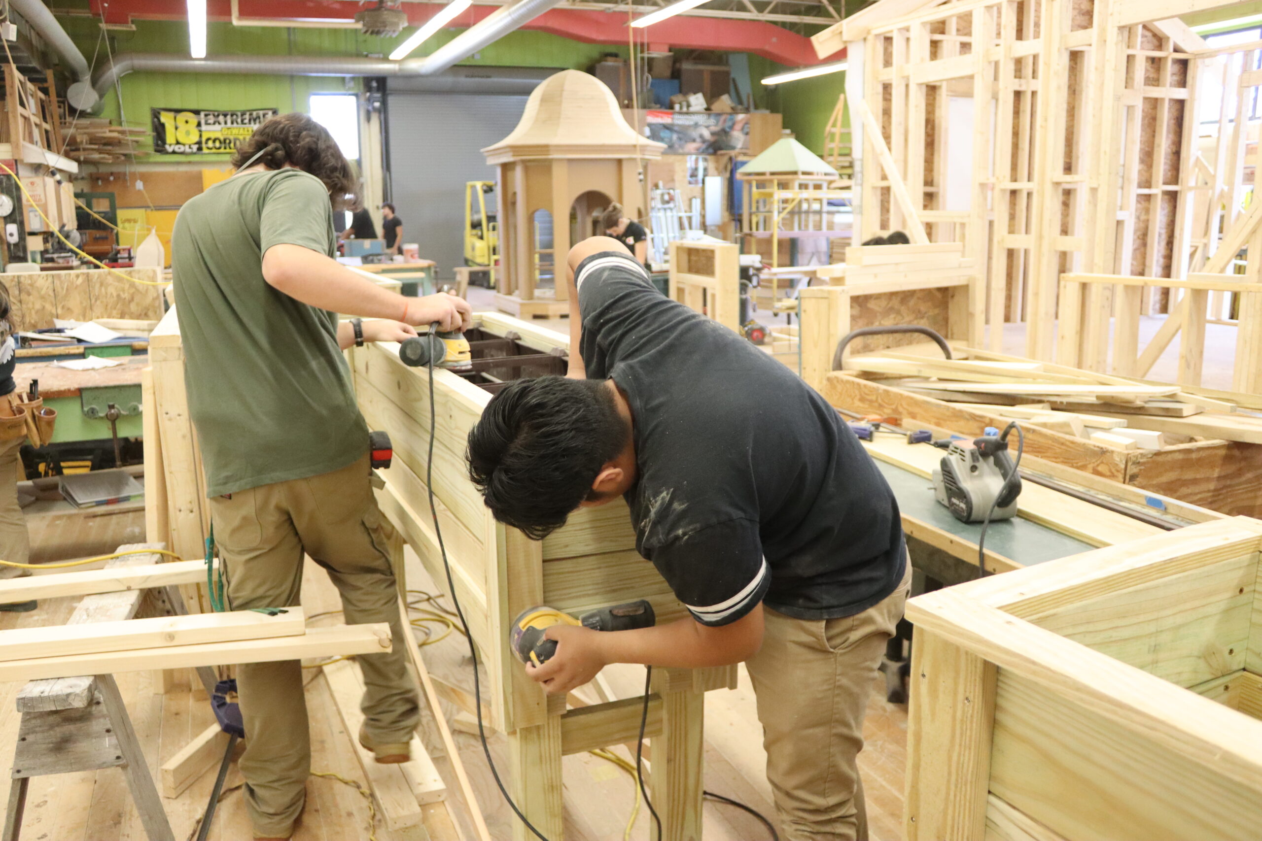 Carpentry student about to saw a piece of wood